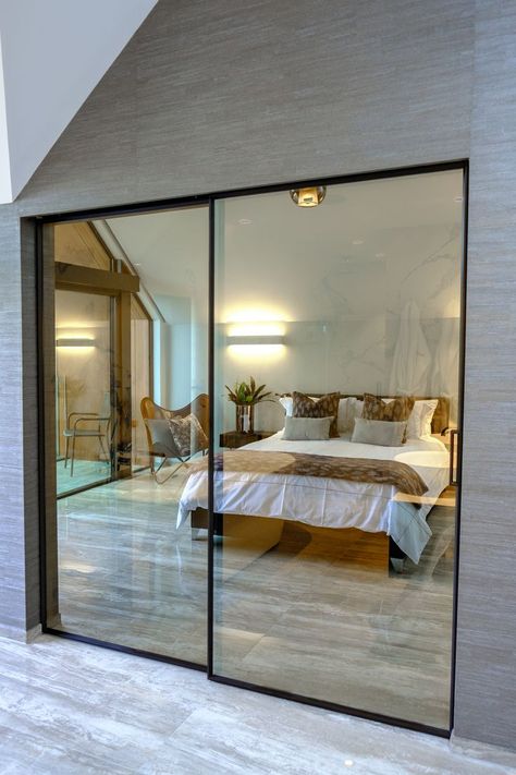 The slim framed sliding doors were specified with a bronze tinted glass, to offer privacy between the bedroom and bathroom whilst still benefitting from the full glass design. Internal Glass Sliding Doors, Interior Sliding Glass Doors, Bedroom Sets Furniture Queen, Internal Sliding Doors, Bedroom Interior Design Luxury, Hampton House, House Extension Design, Door Design Interior, Tinted Glass