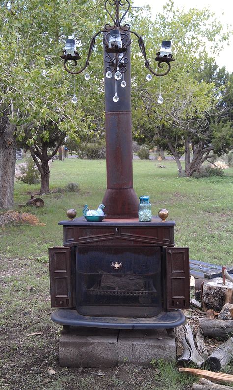 Woodstove & Chandelier. Recycled for re-use. Not pretty enough to be inside but perfect for outside areas. Wood Stove Outdoor Ideas, Outdoor Woodstove Ideas, Outside Wood Stove, Outdoor Wood Stove, Franklin Stove, Outdoor Wood Burner, Outdoor Wood Burning Fireplace, Deck Fire Pit, Wood Stove Fireplace