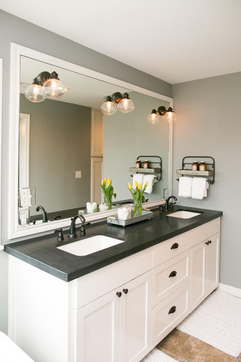 The master bathroom has black granite countertops with double vanity sinks, and a special bathtub given to the homeowner, Deanna King, by her brother, as seen on Fixer Upper. Granite Bathroom, Dark Countertops, Black Granite Countertops, Bathroom Vanity Designs, Concrete Bathroom, Black Countertops, Countertop Decor, Bad Inspiration, Double Vanity Bathroom