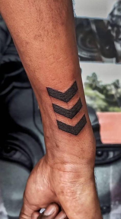 The Meanings Behind The Arrow Tattoo: A Growing Trend Side Arm Wrist Tattoo, Small Gym Tattoos For Men, Arrow On Wrist Tattoo, Arrow Tattoo Ideas Men, Four Arrows Tattoo, Mens Arrow Tattoo Forearm, Men Arrow Tattoo Arm, Chevron Arrow Tattoo, Hand Arrow Tattoo