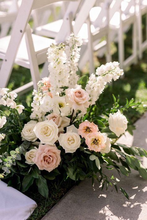 soft pink and white aisle floral arrangement #socalweddingplanner #timelessweddingcolors White Ground Floral Arrangement, White Ceremony Chairs, Pink And White Wedding Florals, Wedding Pergola Flowers, Floral Aisle Wedding, Wedding Aisle Flowers On Ground, Church Flowers Wedding, Flower Walkway, White And Pink Wedding Flowers