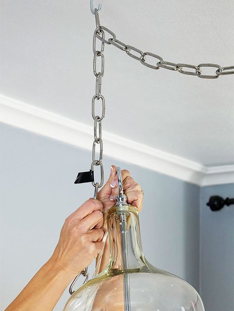 The fixture will come with more chain than you need. To shorten the chain, first hang the fixture from the collar loop. Then hold it at its hanging height and mark with tape the chain link above the one you need to open. Chain Light Fixture, Pull Chain Light Fixture, Chain Lamp, Sink Lights, Diy Pendant Light, Diy Light Fixtures, Diy Chain, Diy Ceiling, How To Hang