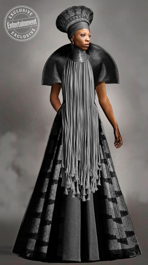 As Wakanda’s queen mother, Ramonda (Angela Bassett) deserves appropriately regal attire. The shoulder mantle is inspired by Victorian ruffs, while her headpiece gets its shape from traditional Zulu hats.  While some costumes have a more handmade look, Carter wanted a sleek, futuristic style for Ramonda. For the headpiece, she recruited a special 3-D printer in Belgium that had the technology to print a flexible, perfectly symmetrical hat. “I felt that there would be people who would make beautif Queen Ramonda, Panthers Outfit, Panther Costume, Black Panther Costume, Curated Fashion, Afro Queen, Afrikaanse Mode, Black Panthers, African Inspired Fashion