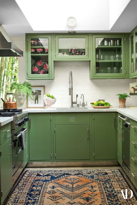 We're green with envy. #green #paint #kitchen #cabinets #vintage #Persianrug #kettle #sink #glass #hood #dishwasher #antique Kabinet Dapur, Interior Design Per La Casa, Green Kitchen Cabinets, Green Kitchen, Dakota Johnson, Architectural Digest, House Inspo, Dream Home Design, 인테리어 디자인