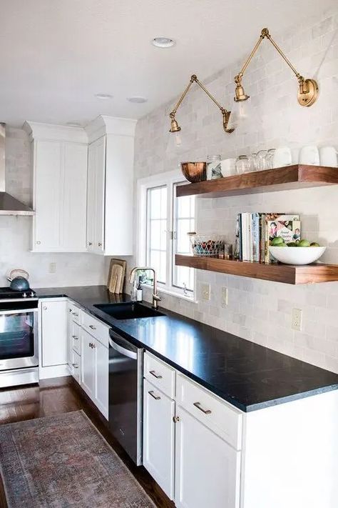 a white farmhouse kitchen with shaker cabinets, black soapstone countertops, a neutral tile backsplash and open shelving Black Countertops Kitchen, White And Black Kitchen, White Cabinets Black Countertops, Kitchen Black Counter, Home Painting Ideas, Plants Kitchen, White Cabinets White Countertops, Black Kitchen Countertops, Black And White Kitchen