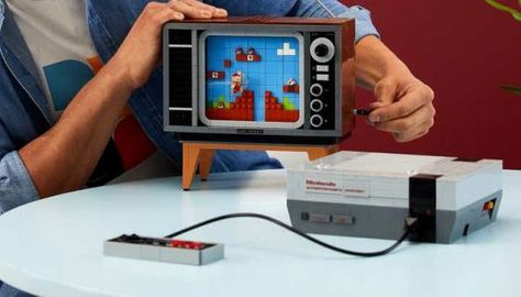 Re-create some of your earliest gaming memories with LEGO's NES Building Kit. Continue reading LEGO releasing classic NES Building Kit at Nerdvana. Super Mario Theme, Mario Day, Mario Theme, Nes Console, Lego Mario, Lego Shop, Super Mario Nintendo, Nintendo Entertainment System, Lego Super Mario