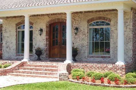 Raised Porch with Brick Pavers and croker sack paint application on French design. By AAA Homes of MS, LLC. Flared Brick Front Porch Steps, Flared Front Porch Steps, Brick Steps Front Porch Farmhouse, Front Porch Brick Steps Ideas, Exterior Front Steps Ideas, Curved Brick Steps, Brick Front Porch Steps, Brick Stairs Front Porch, Brick Entry Steps