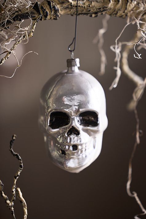 Accent your spooky season décor with this glass skull ornament, each one hand-crafted in Germany. | Skull Glass Ornament in Silver at Terrain Spooky Christmas Decorations, Head Ornaments, Pumpkin Planter, Skeleton Head, Organic Ceramics, Fall Bows, Pumpkin Candles, Glass Cloche, Glass Pumpkins