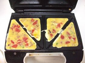 My sister told me about this little trick this past summer for making omelets. Now, I wouldn't go out and buy a sandwich maker just to make ... Toaster Recipes, Breakfast Sandwich Maker Recipes, Camping Recipes Breakfast, Easy Omelet, Sandwich Maker Recipes, Breakfast Sandwich Maker, Waffle Maker Recipes, Sandwich Bar, Gourmet Sandwiches