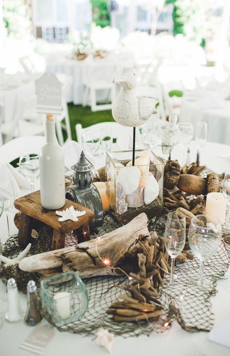 This table scape shows an upscale beach theme with natural beach elements  Photo via Project Wedding Beach Theme Centerpieces, Nautical Centerpiece, Driftwood Wedding, Beach Centerpieces, Diy Beach Wedding, Beach Wedding Decorations Reception, Beach Wedding Centerpieces, Beach Wedding Inspiration, Beach Diy