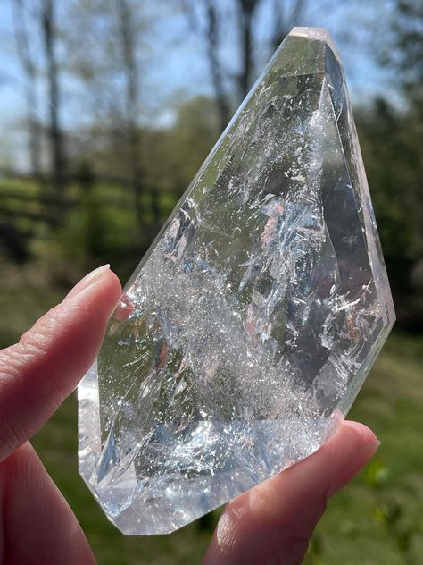 Clear Quartz Freeforms, directly sourced from the crystal-rich mines of Brazil. Each piece is a masterpiece of nature, meticulously crafted to showcase the mesmerizing clarity and purity of quartz. Perfect for crystal enthusiasts, healers, or anyone seeking to enhance their space with positive energy and aesthetic beauty. Whether displayed as a focal point in your home or used for meditation and spiritual practices, these freeforms are sure to enchant and inspire.  Weight: 0.190 kg Aesthetic Beauty, Spiritual Practices, Clear Quartz, Positive Energy, Focal Point, Brazil, Meditation, Spirituality, Charms