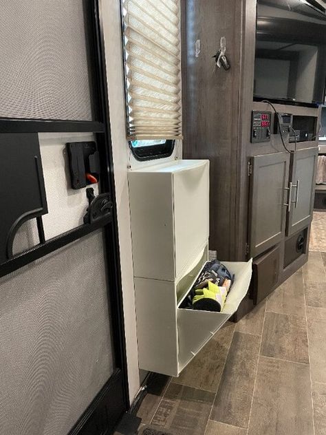 Camper Hidden Storage, Rv Storage Clothes, Camper Pet Ideas, Shoe Storage Rv Travel Trailers, Rv Boot Storage Ideas, Under Camper Storage, Rv Ikea Storage, Shoe Storage In Camper, Adding Storage To Camper