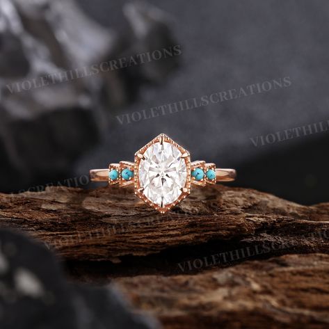 Vintage oval shaped moissanite engagement ring turquoise wedding ring rose gold rings for women promise ring round cut turquoise ring ⨞Handmade item                                                                                                       ⨞Materials: 14k, 18k Gold, Rose gold, White gold Ring size can be choose from the selection box. ⨞Engagement ring -Center Stone - Moissanite  Shape -Oval Cut  Size - 6*8m -Side Stones -Turquoise  Shape - Round cut    -Band Width - About 1.5mm ⨞Our Service                                                                                                       ⨞Customized or Engraving                                       Customized or Engraving service are available. If you have ideas on the design of the ring, please contact with us and give us t Wedding Rings With Turquoise Accent, Simple Country Engagement Rings, Turquoise And Opal Ring, Unique Engagement Rings Turquoise, Gold Western Engagement Rings, Diamond And Turquoise Engagement Ring, Western Promise Rings, Western Rings Engagement, Country Engagement Rings