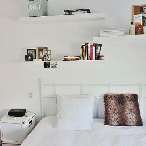 White shelving practically disappears against matching white walls, leaving the illusion of floating books and art. Shelves Above Bed, White Shelving, Shelf Above Bed, Floating Shelves Bedroom, Shelf Decor Bedroom, Decor Above Bed, White Floating Shelves, Ideas For Decorating, Bedrooms Ideas