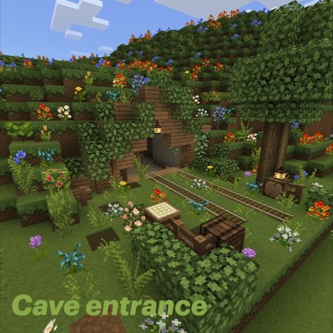 A cozy wood entrance of a mineshaft, including lush flowers, leaves, and trees. Enchantments Minecraft, Minecraft Sanctuary, Entrance Minecraft, Fairycore Minecraft, Minecraft Mine Entrance, Mine Entrance, Minecraft Enchantments, Minecraft Mine, Entrance Idea