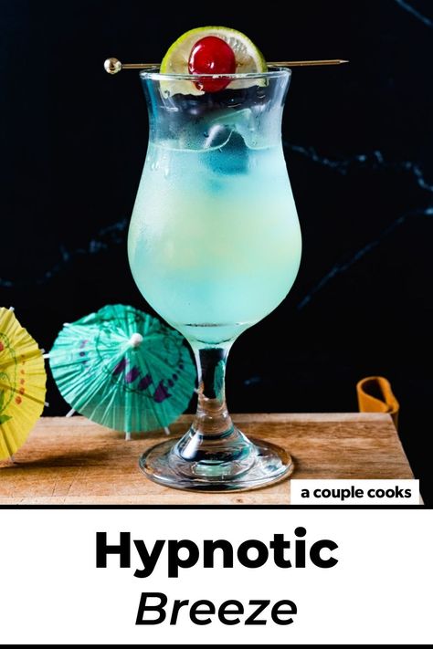 This Hpnotiq drink, the Hypnotic Breeze, stars the fruity blue liqueur with tropical flavors like pineapple and lime. It's a stunner! #hpnotiq #hypnotic #hypnoticdrink #hpnotiqdrink #hypnoticbreeze #beachdrink Hypnotic Drinks, Hpnotiq Drinks, Girls Night Drinks, Alcohol Spirits, Coconut Drinks, Blue Drinks, Yummy Alcoholic Drinks, Happy Hour Drinks, Rum Drinks