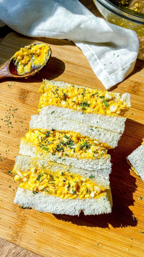 3 Japanese egg sandwich slices served on a wooden board, with a wooden spoon next to them. Japanese Milk Bread Sandwich, Salty Brunch Ideas, Egg Sando Recipe, School Sandwich Ideas, Quick Sandwich Ideas, Japanese Snacks Recipe, Egg Sandwich Ideas, Japanese Egg Salad Sandwich Recipe, Korean Egg Sandwich