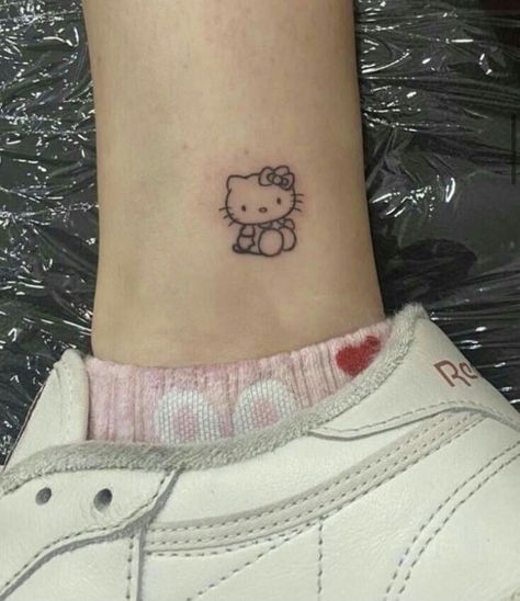 The best way to show your love for hello kitty is to get a tattoo of her! This whimsical character is sure to make a great addition to your body art collection. Cute Small Hello Kitty Tattoos, Cute Hello Kitty Tattoo Ideas, Sanrio Tatoos, Hello Kitty Tattoo Small, Tatuajes Hello Kitty, Tatuajes Hello Kitty Tattoos, Little Cute Tattoos, Sanrio Tattoo Ideas, Small Hello Kitty Tattoo