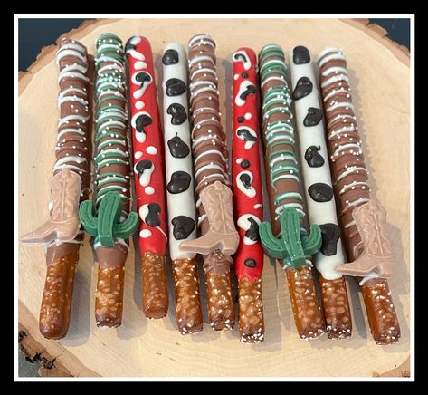 We will only be accepting orders for March 1st delivery and forward. We can not accommodate orders prior to March 1st.... they will be refunded if placed for delivery prior. We appreciate your business and understanding!  Western themed chocolate covered pretzels, individually wrapped and ribboned! You can specify colors desired as well!   Absolutely delicious, these cute and unique themed treats are the perfect addition to your next event!  Thanks for your interest, happy shopping! *Made in a facility that also uses peanuts* Rodeo Theme Dessert Table, Rodeo Treats Western Theme, Western Theme Party For Adults Food, My First Rodeo Snack Ideas, My First Rodeo Snack Table, Rodeo Party Snack Ideas, Rodeo Dessert Ideas, Western Chocolate Covered Pretzels, Western Party Treats