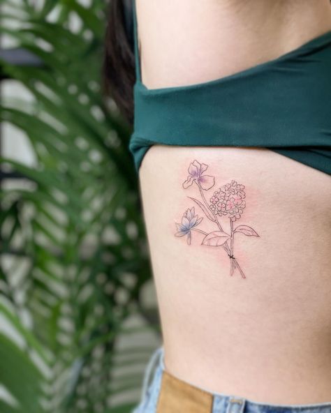 💐 freshly inked intentional, symbolic custom rib bouquet for A. Pink hydrangea also known for heartfelt emotion; purple iris reflecting wisdom, strength and courage; and then a blue lotus honoring the spirit beyond senses, peace from the kind of wisdom after suffering. Minimalist fine line work with some subtle color 🥰 looking forward to how this heals. Big love to @districtlocal for connections x community that made this possible!! This second win from our LNY Tattoo Giveaway was redeemed ... Blue Hydrangea Tattoo, Tattoo Giveaway, Tattoo Bouquet, Hydrangea Tattoo, Bouquet Tattoo, Studio Tattoo, Custom Tattoos, Hydrangea Bouquet, Pink Hydrangea