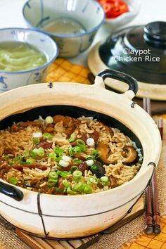 Claypot Chicken Rice is a delicious one-pot meal that can be easily prepared at home. The addition of mushrooms and Chinese sausage makes it even tastier. | RotiNRice.com Claypot Chicken Rice, Claypot Rice, Chinese Sausage, Arroz Frito, Asian Inspired Recipes, Malaysian Food, Chinese Recipes, Chinese Dishes, Chinese Cooking