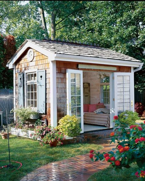 With a cozy daybed and French doors that swing open to a charming and lush garden, this she-shed is the ultimate spot for whiling away a summer afternoon. Adding Windows To Shed, Shed Bedroom Ideas Backyards, Unique Backyard, Backyard Art, Backyard Barn, Wooden Shed, Backyard Getaway, Backyard Storage Sheds, She Shed Ideas