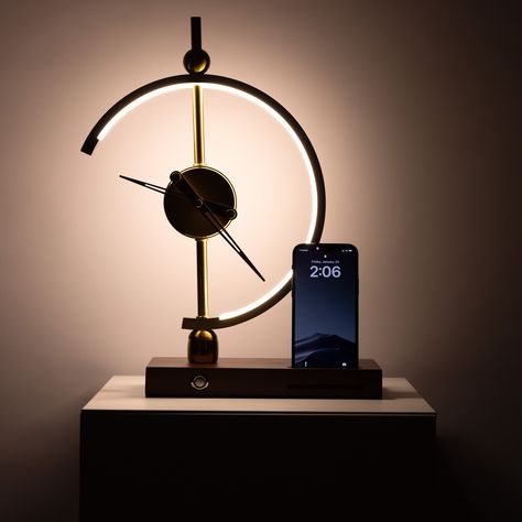 Say hello to your new favorite lighting and charging accessory. Modern minimalist doesn't have to mean boring and bland, so we created the Minimalist LED Clock Lamp that acts as both - a charging station and LED table lamp. Featuring the modern style clock and desk lamp, this unique piece can be a great addition to your bedroom or your office. This one-of-a-kind design marvel is a must-have piece for anyone looking to upgrade their home's interior design. It can be placed in any room which showc Modern Desk Lamps, Unique Desk Lamps, Unique Lamps Table Lamps, Unique Lamp Design, Small Lamps Decor, Desk Lamps Office, Table Accessories Decor, Guys Apartment, Cute Desk Lamp