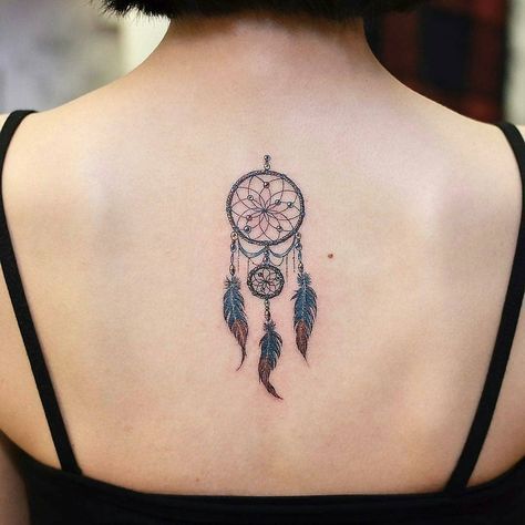 Dreamcatcher tattoo inked at the center of the upper back Dreamcatcher Tattoo Back, Do It Yourself Tattoo, Dreamcatcher Tattoo Meaning, Atrapasueños Tattoo, Small Wave Tattoo, Dream Catcher Tattoo Design, Female Tattoos, Dream Catcher Tattoo, Men Tattoos