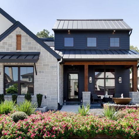 Black House Exterior With Lush Landscaping | HGTV Moody Exterior, Tin Roof House, Black Siding, Modern Exteriors, Black Metal Roof, Moody Modern, Black Cabin, Exterior House Color, Hollywood Homes