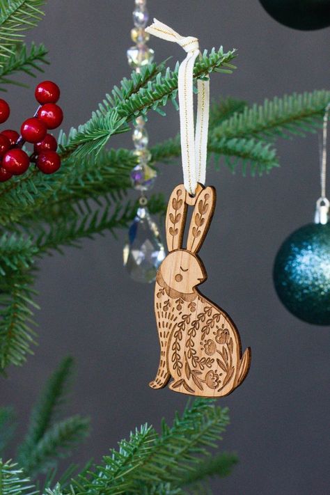 Welcome the winter season with delightful rabbit-themed decorations. Explore folk art ornaments, Glowforge ideas, and unique wooden ties that celebrate the magic of December! December Art, Rabbit 2023, Folk Art Ornament, Glowforge Ideas, Laser Cut Christmas, Wood Tie, Xmas 2022, Folk Art Decor, Ornaments Homemade