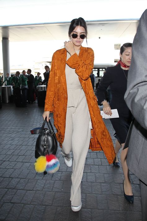 When it comes to jet-setting, Kendall Jenner knows to pack the chicest top layer there is: a bright-colored... Celebrity Travel Style, Celebrity Airport Style, Jenner Photos, Lax Airport, Red Carpet Gowns, Capsule Outfits, Jenner Style, At The Airport, Kendall Jenner Style