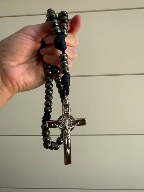 This masculine navy blue paracord rosary is a special edition of our traditional heavyweight paracord rosary. It is made with the same attention to detail and the same rugged paracord, built to last through any adventure, but features an exquisite silver tone and brown enamel St. Benedict crucifix, which is slightly larger and thicker than the traditional paracord rosary. It is a stunning gift for any true gentleman in your life, rugged and manly, but just as stunning. Our rugged paracord rosari Paracord Rosary, True Gentleman, St Benedict, Bible Devotions, Instagram Family, Confirmation Gifts, Inspired Living, Sacred Art, Mother And Father