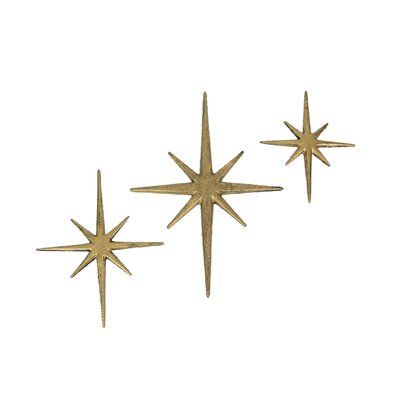 This trio of 8 pointed compass stars adds a wonderful Mid-Century modern touch to your indoor or outdoor decor. Crafted of cast iron, the stars feature an antiqued metallic gold enamel finish to give them a great aged look. The large star measures 8.75 inch long, 0.25 inch wide, 12 inch high; the medium star measures 7 inch long, 0.25 inch wide, 8.75 inch high; and the small star measures 5.75 inch long, 0.25 inch wide, 6.75 inch high. Hang them together or separately for a perfect accent to vin Starburst Wall Decor, Stars Wall Decor, Atomic Starburst, 3d Wall Decor, Big House, Mid Century Modern Decor, Star Wall, Wall Decor Set, Mid Century Modern Art