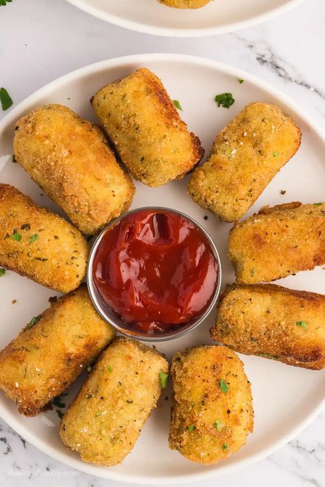 Potato croquettes in a white serving platter. Potatoe Bites Appetizers, Anise Biscotti Recipe, Greek Eggplant Dip, Potatoes Wedges, Greek Eggplant, Potato Croquette Recipe, Italian Potatoes, Croquettes Recipe, Canned Potatoes