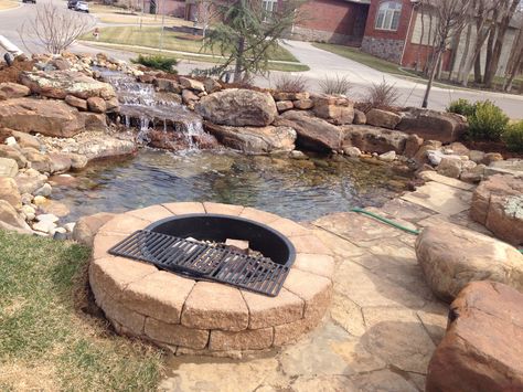 Pond side fire pit Pond With Fire Pit, Backyards Landscapes, Pond Fire Pit, Fire Pit By Pond, Pondless Waterfall And Fire Pit, Yard Waterfall, Fire Pit And Pond, Diy Backyard Fire Pit, Fish Pond With Bridge