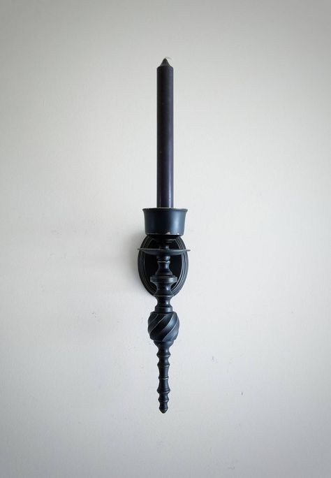 "🖤DESCRIPTION: Gothic Victorian candlesticks make my heart sing  This is a set of vintage solid brass wall candle holders that have been painted black and distressed with the original brass showing through.  They are finished in a top clear enamel coat.   Each one can hold 1 taper candle or 1 pegged votive cup (NOT INCLUDED). 🖤DIMENSIONS: Each piece is 10\" tall, 2 3/4\" wide, and 4\" deep. 🖤MATERIALS: Brass, Paint 🖤SPECIAL NOTE: - Each set of sconces is hand-painted when ordered. Due to this, there might be slight variations from the listing pictures. 🖤Please check out my other: -SCONCES & CANDLESTICKS: https://www.etsy.com/shop/BatterbeeDecor?section_id=28824920 -BATTERBEE SHOP: https://www.etsy.com/shop/BatterbeeDecor" Gothic Woods, Gothic Victorian Home Decor, Aesthetic Gifting, Vintage Wall Candle Holders, Gothic Victorian Homes, Brass Paint, Witchy House, Black Candle Holders, Victorian Home Decor