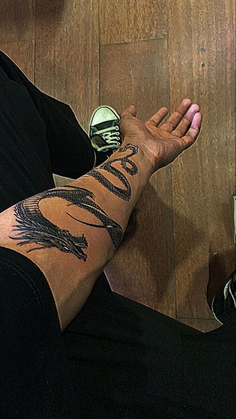 Back Arm Tattoo For Men Ideas, Men’s Dragon Tattoo Arm, Hand Wrapping Tattoo, Dragon Tattoo On Forearm Men, Dragon Tattoo Wrapped Around Arm Men, Dragon Tattoo Lower Arm, Japanese Dragon Tattoos For Men Forearm, Black Dragon Tattoo Arm, Dragon Tattoo Ideas Men