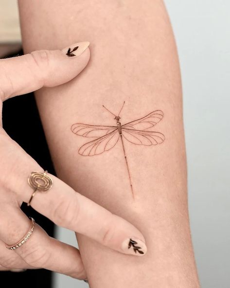 30 Best Dragonfly Tattoo Ideas You Should Check Dragonfly With Initials Tattoo, Dragonfly Tattoo Design Unique, Lace Dragonfly Tattoo, Single Line Dragonfly Tattoo, Dragonfly Tattoo On Wrist, Black And White Dragonfly Tattoo, Dragonfly With Flowers Tattoo, Lotus Dragonfly Tattoo, Dragonfly Arm Tattoo