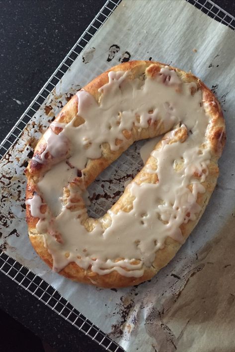 A top view of a Danish Kringle on a cooling rack. Almond Kringle Recipe, Kringle Recipe, Danish Kringle, Racine Wisconsin, Danish Pastry, Family Eating, Dessert Ingredients, Pastry Blender, Cinnamon Buns