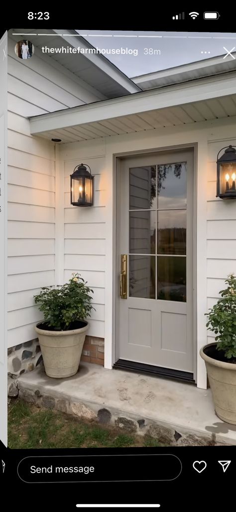 Different Color Garage From House, White House Exterior Garage Door, Side Door Ideas Exterior, Front Door On White Brick House, Cottage Style Garage Doors, Front Porch Office Ideas, Tan Door Exterior, Navy Blue Shutters White House, Garage Doors White Brick House