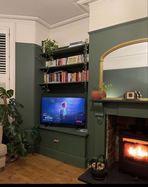 Fire Surround Same Colour As Wall, Dark Green Victorian Living Room, Dark Green Media Wall, Green And Maroon Living Room, Green Front Room Ideas, Brick Chimney Living Room, Tv In Alcove Living Room, Green Media Wall, Living Room Without Fireplace