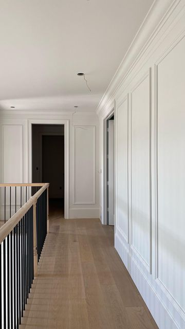 Modern Farmhouse Moulding, Hallway Transitions Interior Design, Two Story Picture Frame Molding, Wall In The Middle Of Living Room, Wainscoting Ideas Hallway Entry Hall, Wall Trim High Ceiling, Foyer Trim Ideas, Long Hallway Trim Ideas, Trimwork On Walls