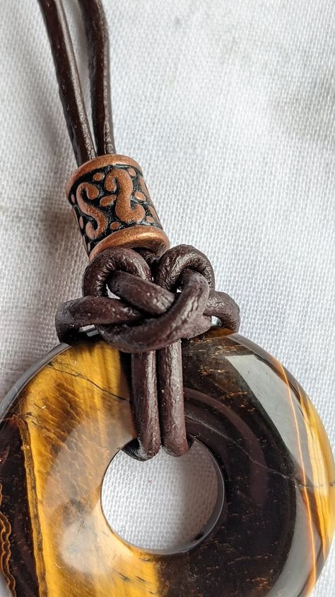 Cat's paw knot with leather. Tiger's eye donut pendant Donut Pendant Necklace, Donut Jewelry, Cats Paw, Diy Nature, Washer Jewelry, Celtic Knot Pendant, Random Crafts, Donut Pendant, Ren Fair