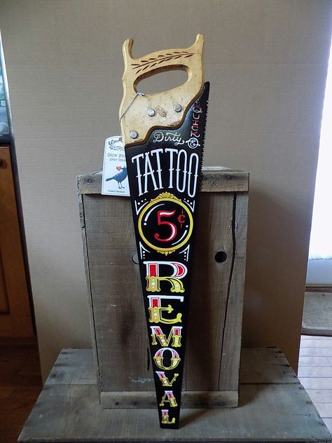 Tattoo Removal Painted Saw by Crow Studio artist Cindy Magee Derby Tattoo, Saw Tattoo, Tattoo Shop Interior, Tattoo Shop Decor, Tattoo Studio Interior, Sign Painting Lettering, Pinstripe Art, Hand Saws, Crust Punk