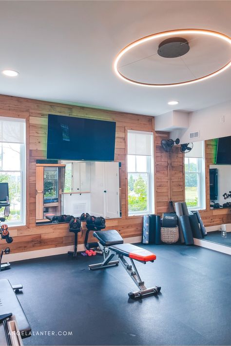 We decided our unfinished walk out basement was the perfect spot for a home gym build. Plae rubber flooring, shiplap wall, mirrors, tv, infrared sauna, ballet barre and pilates reformer, boxwood wall. Find more details about our home gym. Basement Fitness Room. Angela Lanter Unfinished Basement Gym, Office Combo Room, Boxwood Wall, Gym Basement, Modern Home Gym, Home Gym Ideas, Angela Lanter, Basement Gym, Workout Room