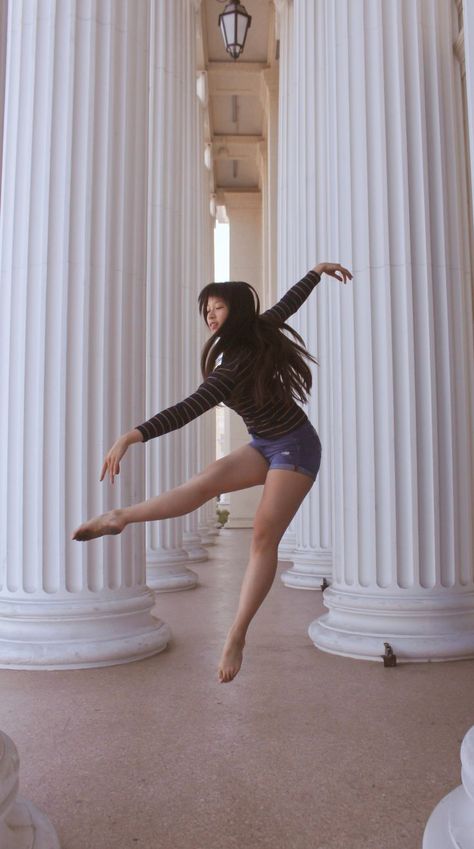 photo taken by @sylvies.photos on instagram; contemporary ballet dance photography of @ sterlinggg.k_ on instagram; photograph of a ballet dancer wearing a dark blue and yellow striped longsleeve shirt and blue jean shorts doing a creative jump dance pose between white columns Dance Photography Jumps, Modern Poses, Dancer Senior Pictures, Coocoo Clock, Contemporary Dance Poses, Jump Dance, Ballet Jumps, Dance Shoot, Dance Jumps