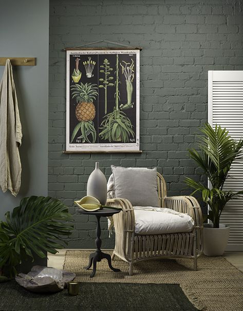 Resene Easy Rider on the brick wall is teamed up with paler Resene Inside Back. Add a botanical print, a jute rug, wicker chair with linen cushions and a potted palm – it’s simple and fresh without being stark. The classic tri-leg side table is painted in Resene Wireless, the urn on top is in Resene Triple Rakaia, and the shutter and the plant pot are in Resene Triple Merino. Painted Brick Interior Wall, Painted Brick Wall Interior, Interior Brick Wall Ideas, Painted Brick Interior, Brick Wall Ideas, Painted Brick Wall, Brick Wall Living Room, Brick Wall Backdrop, Painted Brick Walls