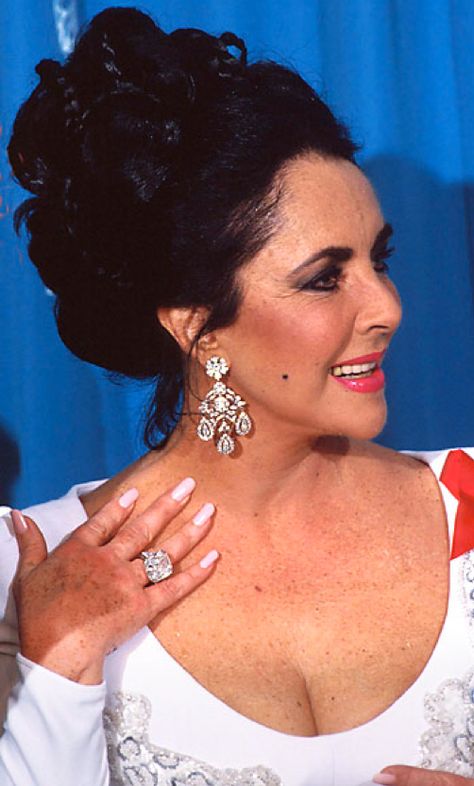 These earrings were favorites of Elizabeth Taylor. When she discovered them in a Paris boutique, they sparkled with paste (glass) gems. She wrote, "A few months later, back in New York, I was getting ready for a party and went to put them on. I opened the box, and the earrings looked all polished up. I put them on. There was something different about how they fit. I said, 'Mike, there's something wrong with my earrings.' He chuckled and said he'd had them made up with real diamonds!" Elizabeth Taylor Diamond, Elizabeth Taylor Jewelry, Mike Todd, Memorable Jewelry, Diamond Chandelier Earrings, Violet Eyes, Jewelry Auction, Elizabeth Taylor, Golden Age Of Hollywood