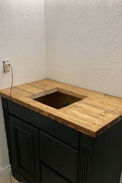 Easy Do It Yourself Vanity Update Diy Wood Countertops Bathroom, Black Bathroom Vanity With Wood Top, Wooden Bathroom Vanity Top, Dark Blue Master Bath, Black Washroom Vanity, Diy Bathroom Vanity Cabinet, Butcher Block Vanity Top, Butcher Block Vanity Top Bathroom, Diy Bathroom Vanity Top