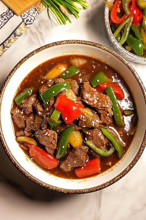 This Crockpot pepper steak recipe delivers tender beef strips and colorful bell peppers simmered in a savory, slightly sweet sauce. The slow cooker brings out incredible flavors, making it the perfect easy dinner for busy nights. Try this recipe today – see full instructions #crockpotrecipes #peppersteak #beefrecipes #easymeals #slowcooker #comfortfood #weeknightdinner #asianinspired #slowcooked Beef With Black Bean Sauce, Beef In Black Bean Sauce, Crockpot Pepper Steak, Crockpot Stuffed Peppers, Pepper Steak Recipe, Bean Sauce, Beef Strips, Healthy Weeknight Meals, Black Bean Sauce